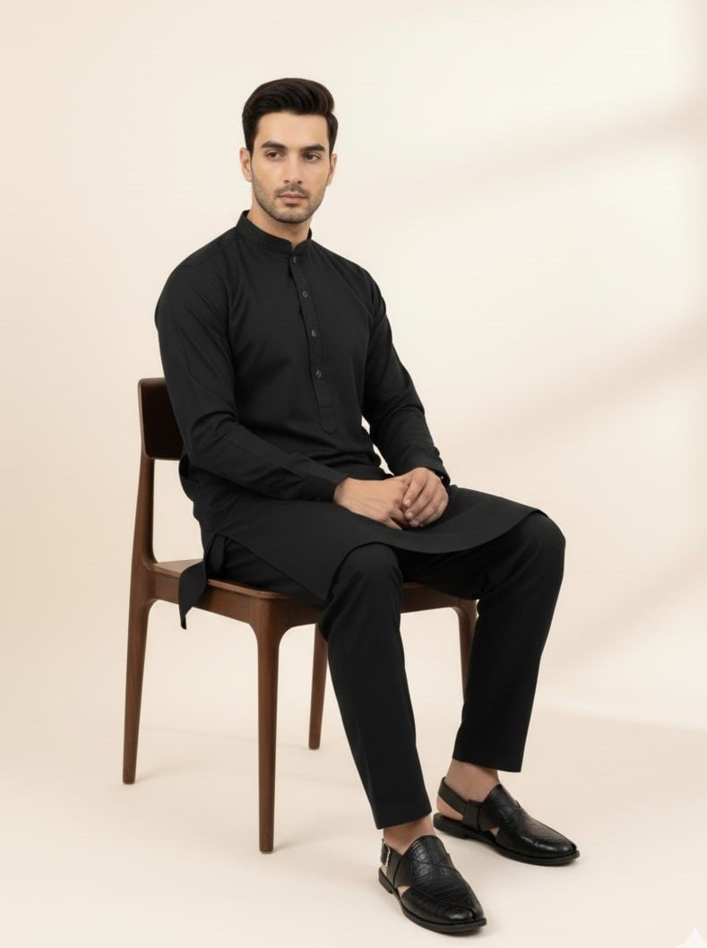 model sitting wearing black shalwar kameez and black peshawari chappal