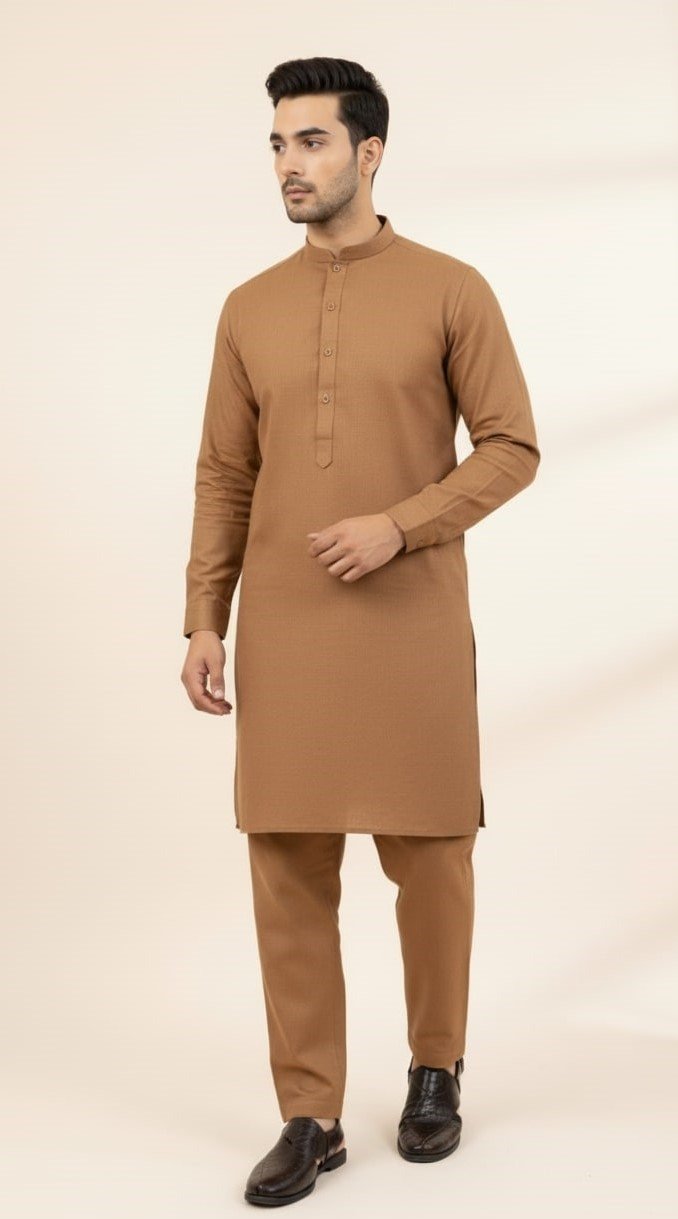 model standing wearing brown shalwar kameez and brown peshawari chappal